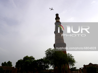 A plane flies past over the Qutub Minar complex ahead of its reopening, as authorities announced various relaxations as part of unlocking th...