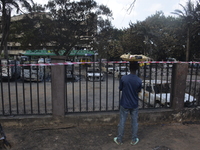 A street hawker stands outside the scene of a gasoline explosion at the Ogun State Property and Investment Corporation Plaza, district of La...