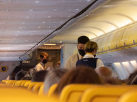 Flight Attentands wearing facemasks during the flight. Flying during the Covid-19 Coronavirus pandemic inside a Boeing 737-800 aircraft of R...