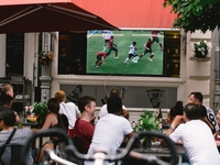 football fans are watching Euro 2020 match between Portugal and Germany in an outdoor restaurant in Bonn, Germany on June 19, 2021 (