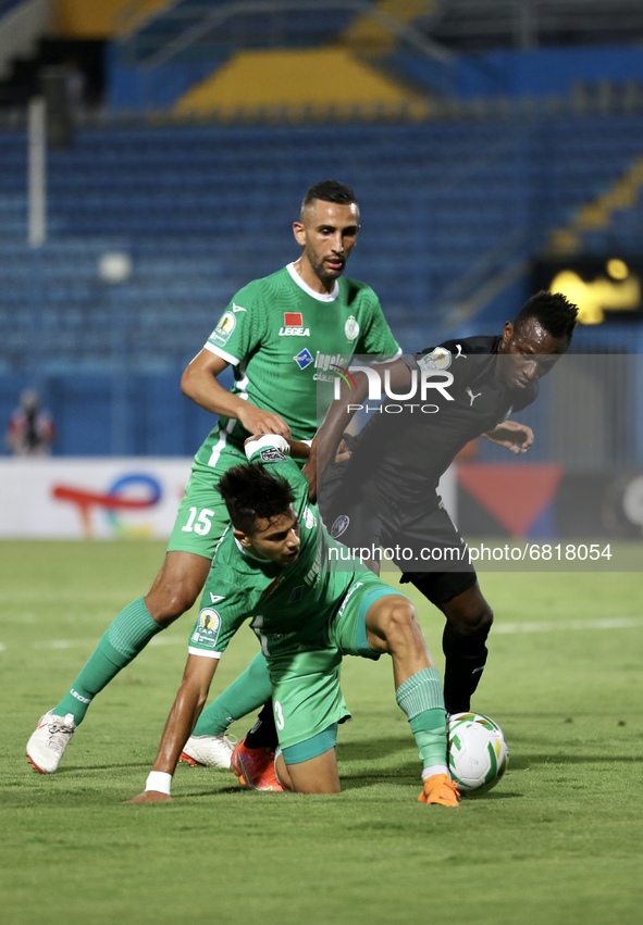 Mohamed Souboul (C-bottom) of Raja fights for the ball against a Pyramid's soccer player  during CAF Confederation Cup Semi-final match betw...