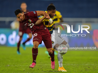 Hernandez player from Venezuela disputes a bid with Mena player from Equador during a match at the Engenhão stadium for the Copa América 202...