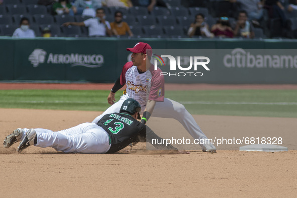 Alexis Wilson #13 of Mexico team slides in the dish of the  second base   during the exhibition match  between the Venezuela  and the Mexico...