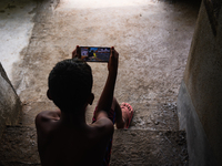 A boy plays with Battlegrounds Mobile India in Tehatta, West Bengal, India on 21 June 2021. Battlegrounds Mobile India, the alternative to P...