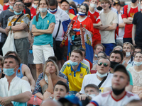 Ukraine supporter (C) watches a live stream alongside with Russian supporters during the UEFA Euro 2020 Championship match between Austra an...