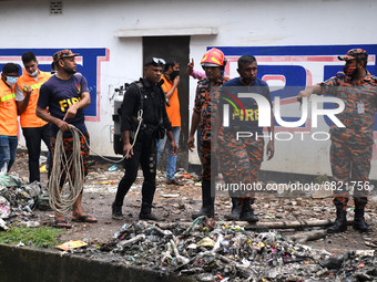 Rescue workers are seen conducting search operations at Jhilpar sewer in the capital Dhaka, Bangladesh on June 22, 2021. (