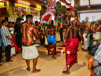 Tamil Hindu devotees perform the Kavadi Attam ritual (a ritual where they are pulled while dancing by hooks driven into their backs as an ac...