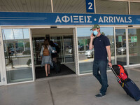 Passengers with face masks as seen at Chania International Airport CHQ in the Greek island of Crete. Crete is a popular travel destination w...