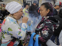 A santera outside the temple of Santa Muerte in Tepito, Mexico City, Mexico, on July 1, 2021, with attendees during the COVID-19 health emer...