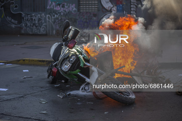 A police motorcycle burns in the middle of the funeral of Luisa Toledo Sepulveda, mother of brothers Rafael(18) and Eduardo Vergara Toledo(1...