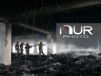 Firefighters work at the site of a fire that broke out on Thursday at Hashem Foods Ltd factory in Rupganj, Narayanganj district, on the outs...