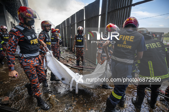 Firefighter's and rescue workers carry the bodies that were recovered after a fire broke out at the Hashem Foods Ltd at Rupganj, on the outs...
