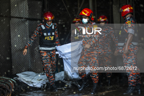 Firefighter's and rescue workers carry the bodies that were recovered after a fire broke out at the Hashem Foods Ltd at Rupganj, on the outs...