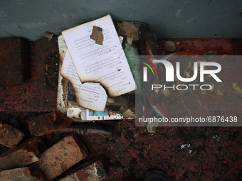 Remains of burnt books inside the damaged residential house where three militants were killed in a military operation in Newa area of Pulwam...