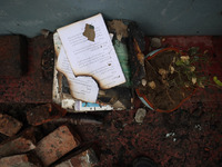 Remains of burnt books inside the damaged residential house where three militants were killed in a military operation in Newa area of Pulwam...