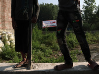 Kashmiri People stand near the damaged residential house where two Militants were killed in a military operation in Srinagar, Indian Adminis...