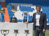 Iker Casillas poses  trophies he has won during his career in Real Madrid   at the Santiago Bernabeu stadium to announce that he will be lea...