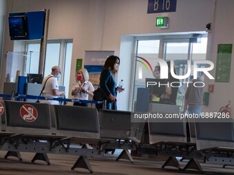 People are checking in to depart at the gate in Athens Airport. Passengers with face masks as seen at Athens International Airport ATH LGAV...
