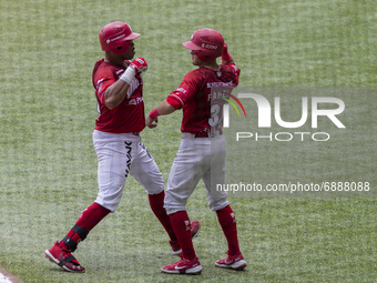 Jesus Fabela  #36  congratulates to Jon Singleton #20  of the Diablos Rojos  after the home run  during the match between Diablos Rojos and...