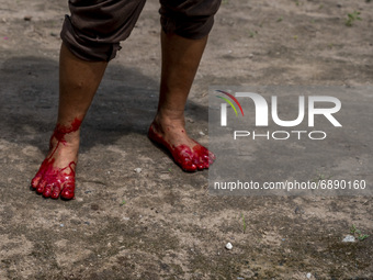 A worker's feet are covered in blood after slaughtering
a goat for sacrifice in Pombewe Village, Sigi Regency, Central Sulawesi Province, I...