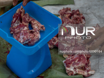 A worker weighs sacrificial beef before it is distributed to the poor in Pombewe Village, Sigi Regency, Central Sulawesi Province, Indonesia...
