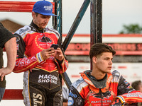  Hans Andersen  (left) checks his phone whilst Jordan Palin  watches the track prep during the SGB Premiership match between Peterborough an...