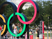 People pose at the 'Rings Across America' exhibit by NBC Universal on the National Mall in Washington, D.C. on July 20, 2021. The olympic ri...