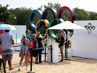 People visit the 'Rings Across America' exhibit by NBC Universal on the National Mall in Washington, D.C. on July 20, 2021. The olympic ring...