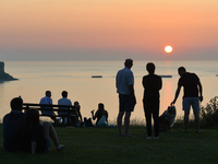 People are watching the sunset near Arromanches.
On Wednesday, July 20, 2021, in Arromanches, Calvados, Normandy, France. (