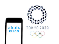 In this photo illustration a Cisco Systems, Inc. logo seen displayed on a smartphone with a Tokyo 2020 Olympic Games logo in the background....