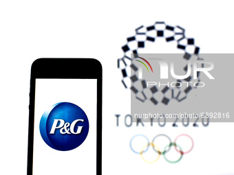 In this photo illustration a Procter & Gamble logo seen displayed on a smartphone with a Tokyo 2020 Olympic Games logo in the background. (