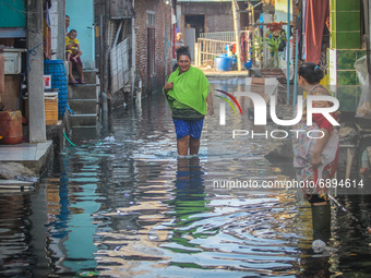 Residents' activities amid tidal flooding in a fishing village in Tambaklorok, Semarang, Central Java Province, Indonesia on July 21, 2021....