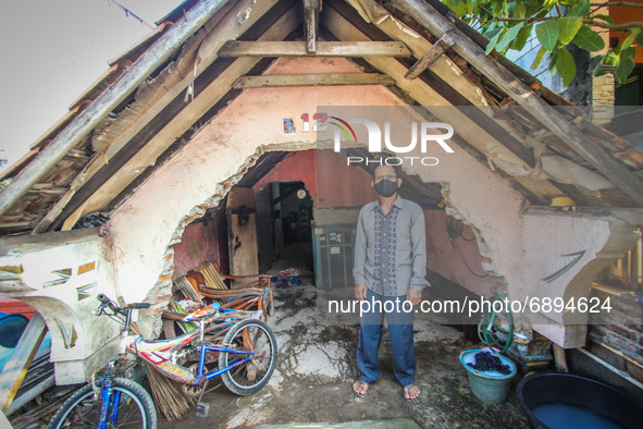 Resident stand in front of their houses in a fishing village in Tambaklorok, Semarang, Central Java Province, Indonesia on July 21, 2021. 