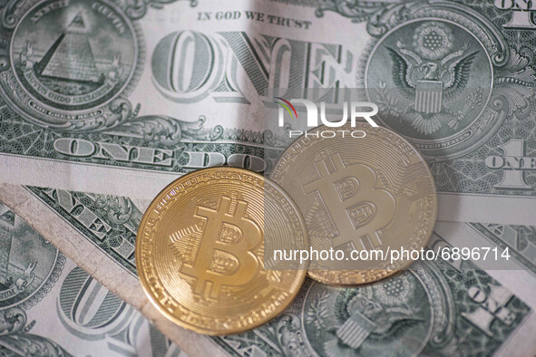 Bitcoin golden physical coin illustration on United States Dollar banknotes. Visual representations of the digital Cryptocurrency Bitcoin wi...