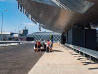 People out of the departure hall of T2 and the Control Tower visible. Departures with the check in desks at Thessaloniki International Airpo...