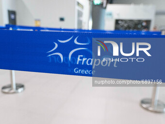 Logo of Fraport Greece. People in the departure hall with the check in desks at Thessaloniki International Airport Makedonia SKG LGTS in Nor...
