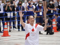 Kabuki actor Nakamura Kankuro runs as the last runner for Tokyo during the arrival ceremony for Tokyo Olympic Torch Relay in Shinjuku on Jul...