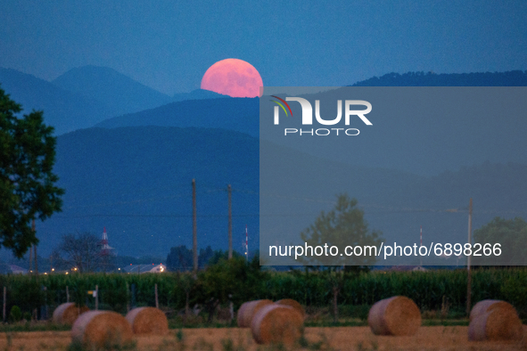 The almost full Moon, is 95% rises over the skies of Rieti, Italy on July 23, 2021. he month of July will be the only one in 2021 to host 5...