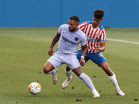 Memphis Depay of Barcelona and Ilyas Saira of Girona compete for the ball during the pre-season friendly match between FC Barcelona and Giro...