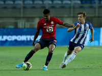 Reinildo Mandava of Lille OSC (L) vies with Francisco Conceicao of FC Porto during the pre-season friendly football match between FC Porto a...