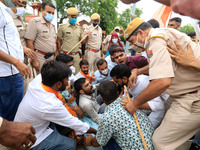 Police personnel detain Akhil Bharatiya Vidyarthi Parishad 'ABVP' activists as they protest against the state government for their demands a...