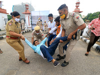 Police personnel detain Akhil Bharatiya Vidyarthi Parishad 'ABVP' activists as they protest against the state government for their demands a...