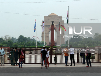People click pictures at the India Gate War memorial, as they gather to pay tribute to Kargil martyrs during the 22nd anniversary of India's...