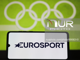 Eurosport  logo is displayed on a mobile phone screen photographed with Olympic rings symbol on the background for illustration photo. Leszc...