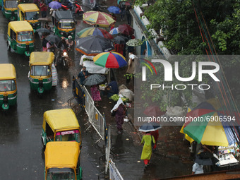 People wading through the road during heavy rainfall, in Kolkata, India on July 26,2021.   (