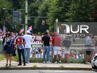 Supporters watch as demonstrators march under an overpass during a demonstration for Cuban rights in Washington, D.C. on July 26, 2021 (