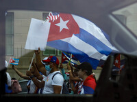 Demonstrators are seen through a car window as they march from the White House to the Cuban Embassy in Washington, D.C. on July 26, 2021 (