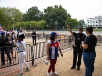 Demonstrators argue with Secret Service officers as they move back thousands of protestors from Lafayette Park in front of the White House d...