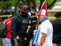 A demonstrator pleads with a Secret Service officer as they move back thousands of protestors from Lafayette Park in front of the White Hous...
