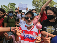 A supporter of Kais Saied holds an onion during a demonstration held in front of the building of the Tunisian parliament in Bardo, in the ca...